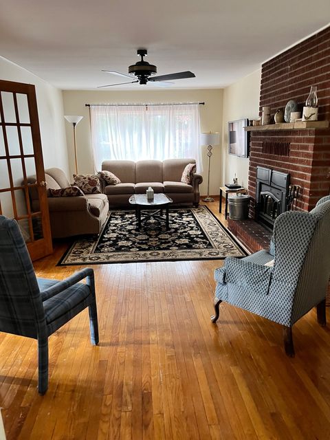 A sitting room with a brick fireplace.